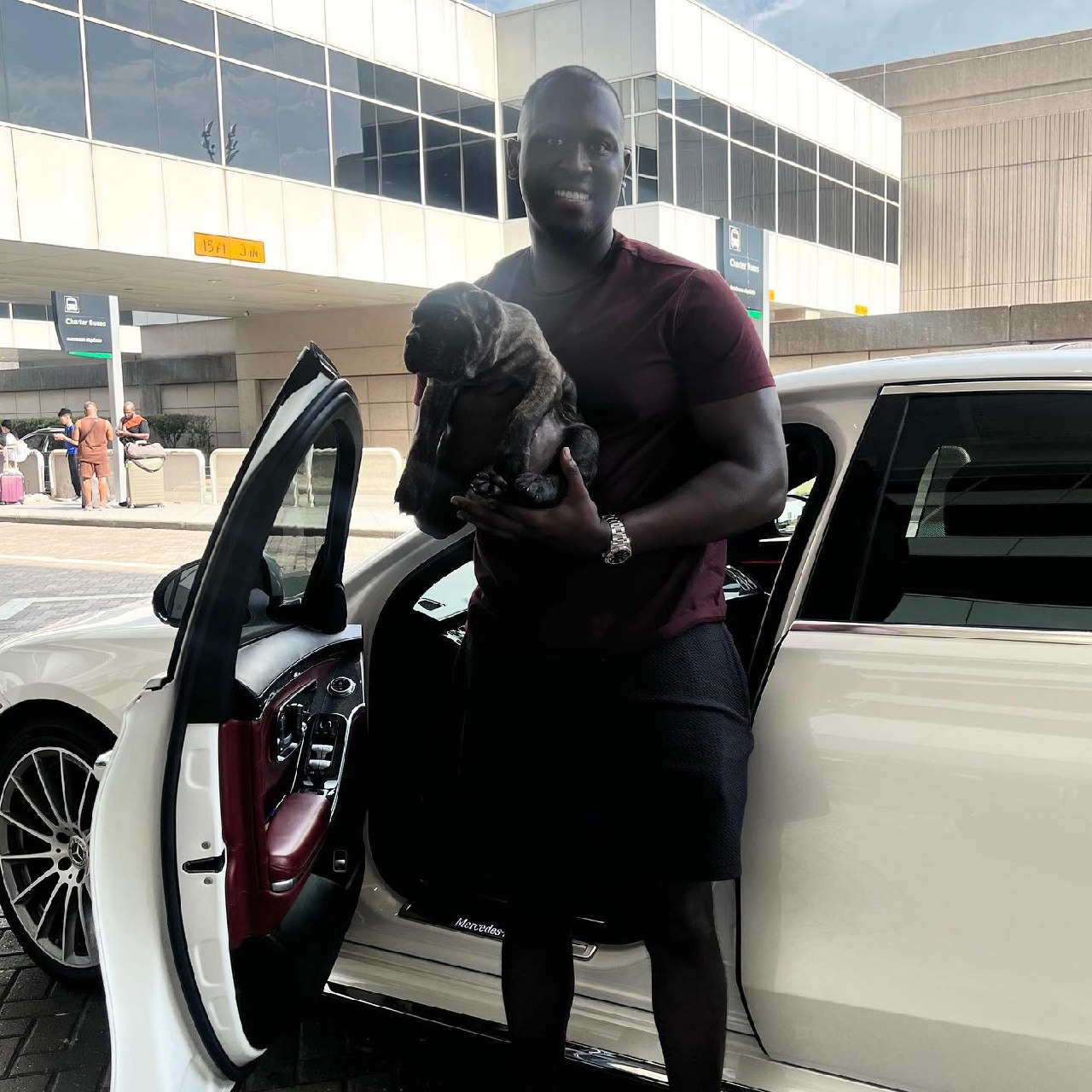 A buyer collecting his Cane Corso puppy at Dallas Fort Worth International Airport